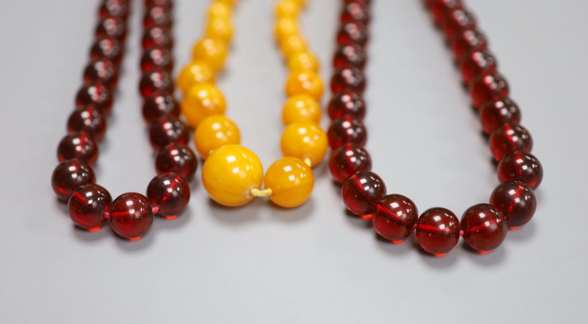 Two faux amber necklaces, 148cm and 44cm.